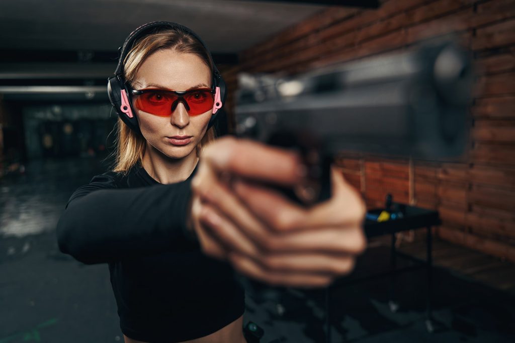 focused-beautiful-shooter-in-earmuffs-shooting-a-h-min