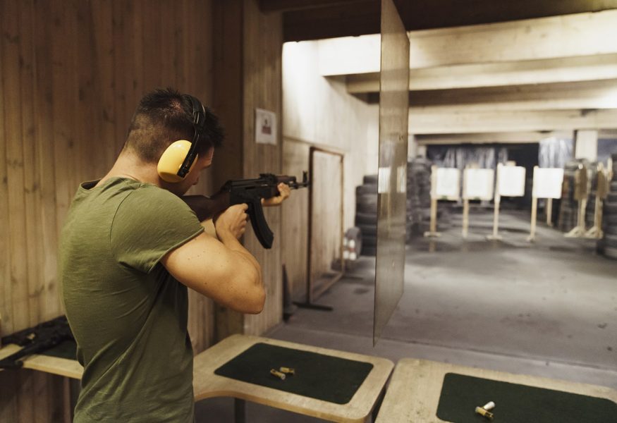 man-aiming-with-a-rifle-in-an-indoor-shooting-ran-min